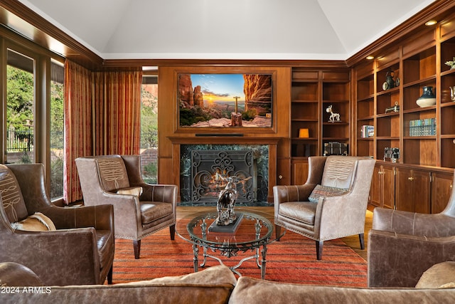 sitting room with lofted ceiling, plenty of natural light, and a fireplace