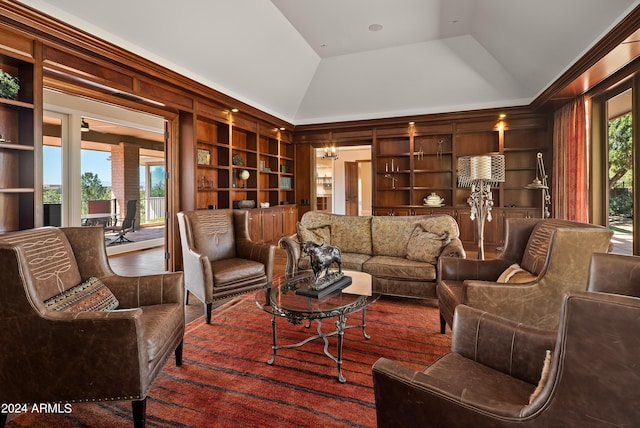 living area with built in features and high vaulted ceiling