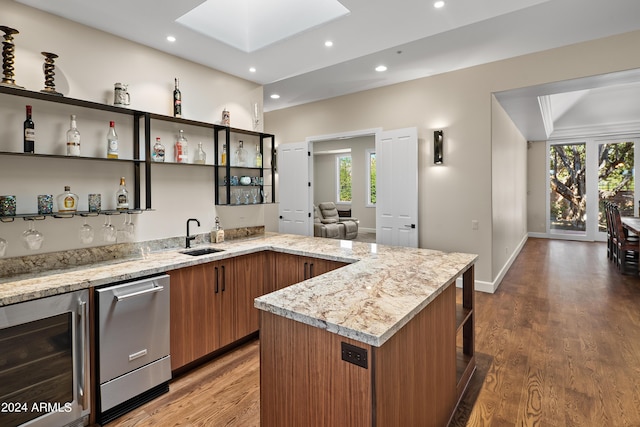 kitchen with open shelves, wine cooler, wood finished floors, and brown cabinets