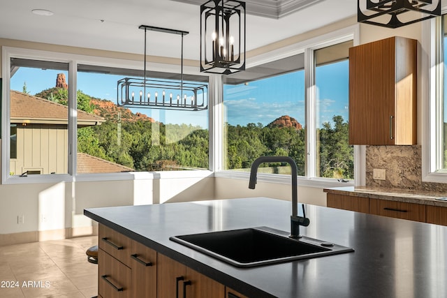 kitchen with dark countertops, brown cabinets, and a sink