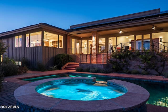 view of swimming pool featuring a pool with connected hot tub, a ceiling fan, and a patio area