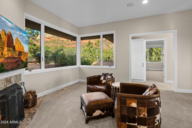 sitting room featuring visible vents, baseboards, carpet, recessed lighting, and a fireplace