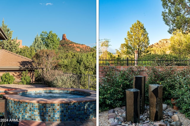 view of swimming pool featuring an in ground hot tub and fence