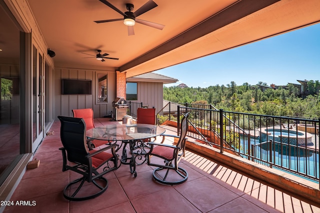 view of patio / terrace with outdoor dining space, a pool with connected hot tub, and a ceiling fan