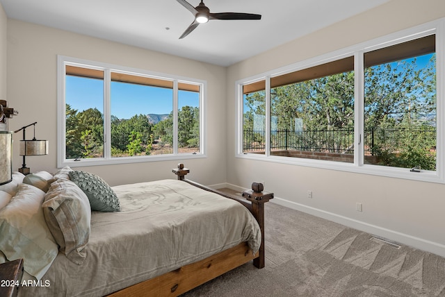 carpeted bedroom with visible vents, ceiling fan, and baseboards