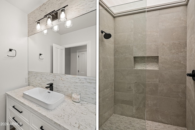 full bath with decorative backsplash, vanity, and a walk in shower