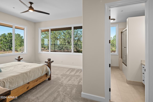 bedroom with light carpet, light tile patterned floors, and baseboards