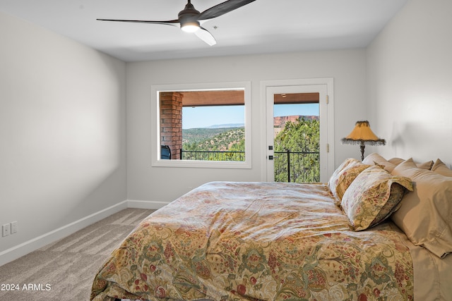 carpeted bedroom with access to exterior, baseboards, and ceiling fan