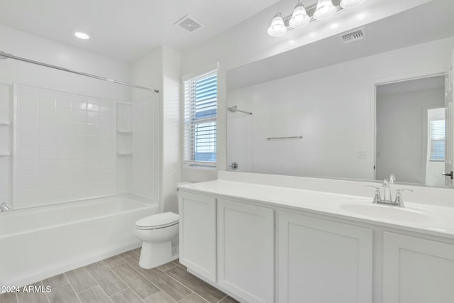 full bathroom with vanity, toilet, and washtub / shower combination