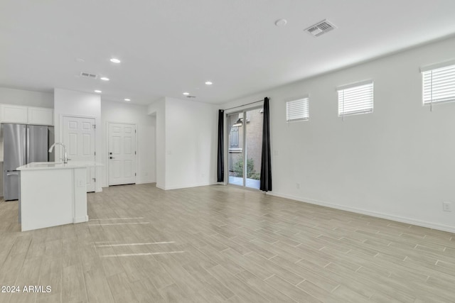 empty room featuring light hardwood / wood-style flooring and sink