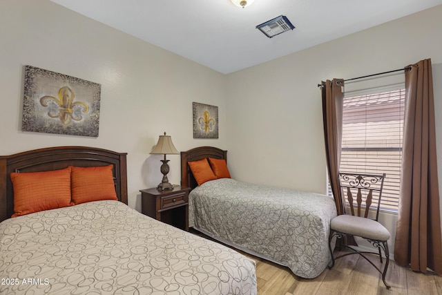 bedroom with wood-type flooring