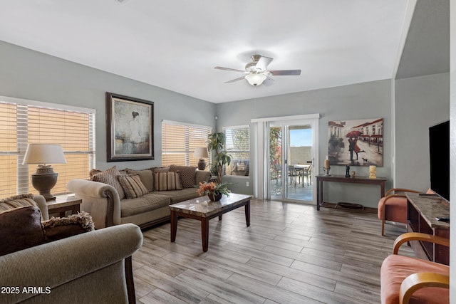 living room featuring ceiling fan and light wood-type flooring