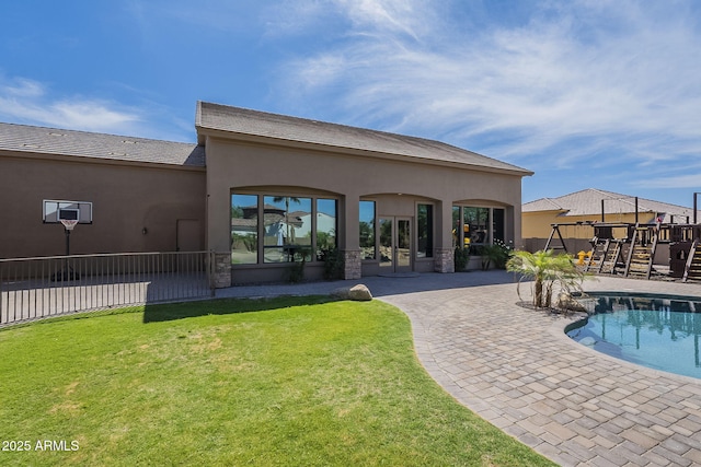 10033 W Jj Ranch Rd, Peoria, AZ 85383 - rear view of property featuring stucco siding and a patio area