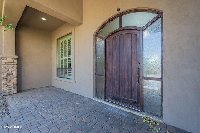 10033 W Jj Ranch Rd, Peoria, AZ 85383 - doorway to property featuring stucco siding and a patio area