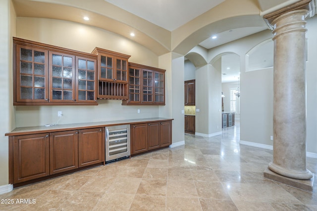 10033 W Jj Ranch Rd, Peoria, AZ 85383 - bar with decorative columns, wine cooler, recessed lighting, arched walkways, and baseboards