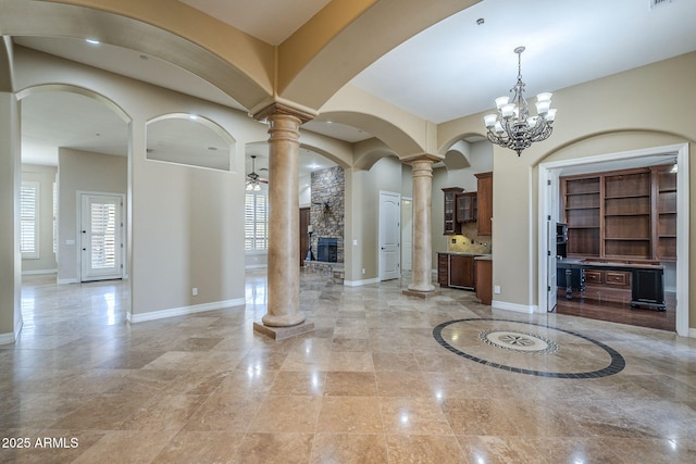 10033 W Jj Ranch Rd, Peoria, AZ 85383 - entrance foyer featuring ornate columns, a chandelier, baseboards, ceiling fan, and arched walkways