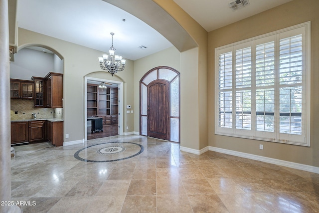 10033 W Jj Ranch Rd, Peoria, AZ 85383 - entrance foyer featuring a chandelier, arched walkways, and baseboards
