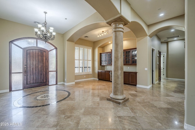 10033 W Jj Ranch Rd, Peoria, AZ 85383 - foyer entrance with baseboards, a chandelier, arched walkways, and ornate columns
