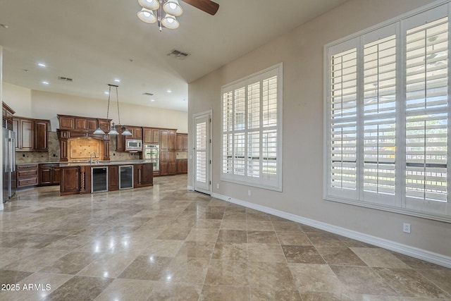 10033 W Jj Ranch Rd, Peoria, AZ 85383 - unfurnished living room featuring beverage cooler, baseboards, plenty of natural light, recessed lighting, and a high ceiling