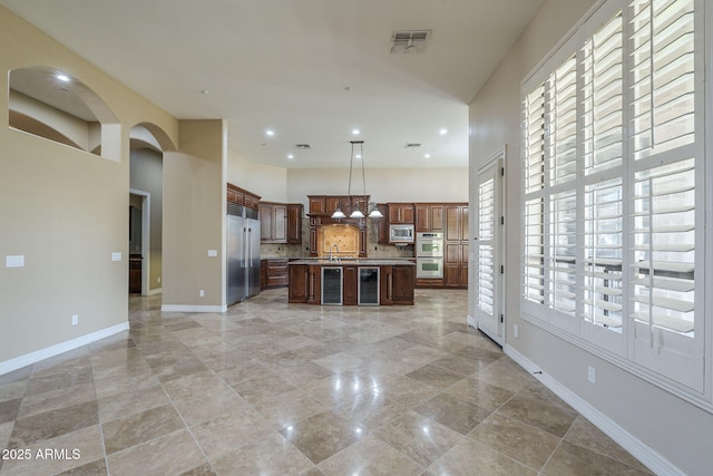 10033 W Jj Ranch Rd, Peoria, AZ 85383 - kitchen with open floor plan, built in appliances, wine cooler, light countertops, and backsplash