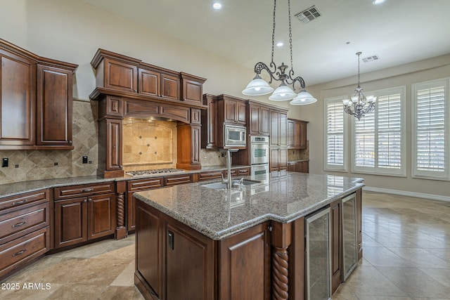 10033 W Jj Ranch Rd, Peoria, AZ 85383 - kitchen featuring beverage cooler, a sink, tasteful backsplash, stainless steel appliances, and a kitchen island with sink