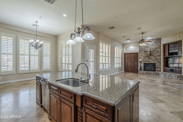 10033 W Jj Ranch Rd, Peoria, AZ 85383 - kitchen featuring a sink, a stone fireplace, stainless steel dishwasher, healthy amount of natural light, and recessed lighting