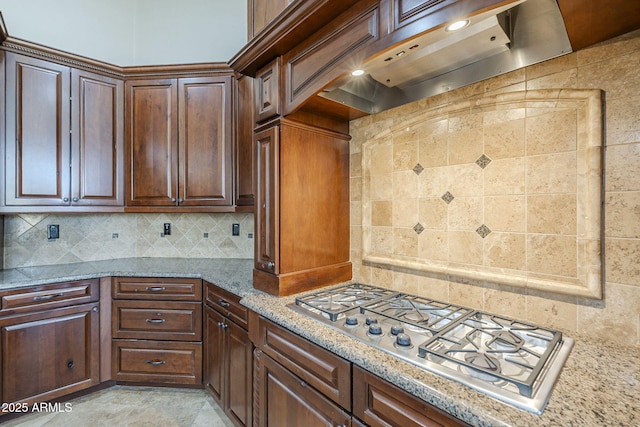 10033 W Jj Ranch Rd, Peoria, AZ 85383 - kitchen featuring stainless steel gas cooktop, premium range hood, backsplash, and light stone countertops