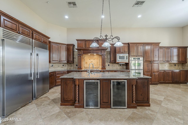 10033 W Jj Ranch Rd, Peoria, AZ 85383 - kitchen with beverage cooler, built in appliances, a sink, stone counters, and recessed lighting