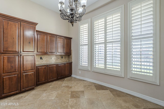10033 W Jj Ranch Rd, Peoria, AZ 85383 - unfurnished dining area with a chandelier and baseboards