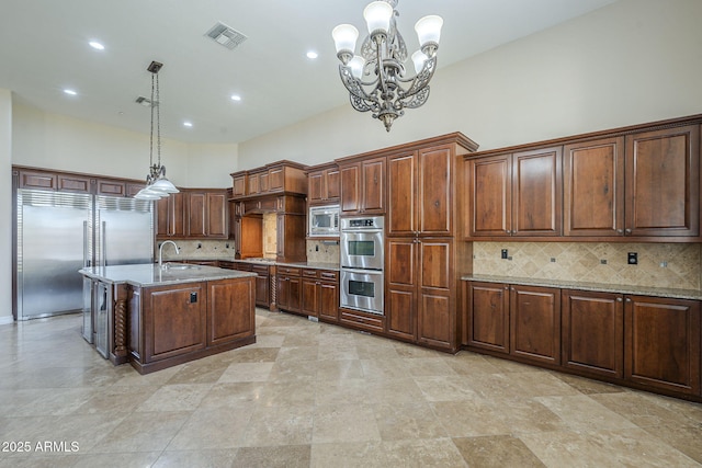 10033 W Jj Ranch Rd, Peoria, AZ 85383 - kitchen featuring built in appliances, a sink, decorative backsplash, light stone countertops, and a chandelier