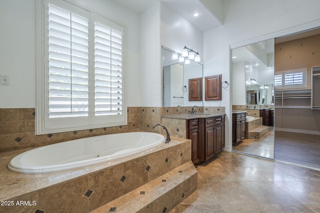 10033 W Jj Ranch Rd, Peoria, AZ 85383 - full bathroom with vanity, a jetted tub, and tile patterned flooring