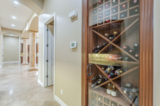 10033 W Jj Ranch Rd, Peoria, AZ 85383 - wine room with arched walkways, ornate columns, baseboards, and recessed lighting