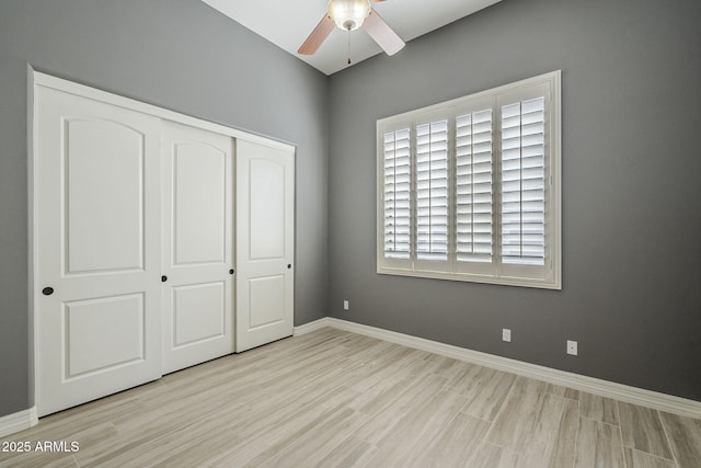 10033 W Jj Ranch Rd, Peoria, AZ 85383 - unfurnished bedroom with a closet, wood finished floors, baseboards, and a ceiling fan