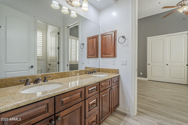 10033 W Jj Ranch Rd, Peoria, AZ 85383 - full bathroom with a ceiling fan, double vanity, baseboards, and wood finished floors