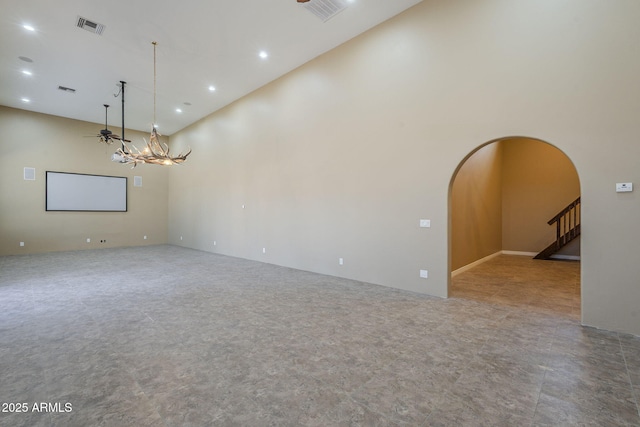 10033 W Jj Ranch Rd, Peoria, AZ 85383 - empty room with arched walkways, a high ceiling, recessed lighting, and a ceiling fan