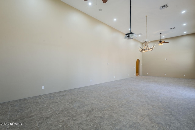 10033 W Jj Ranch Rd, Peoria, AZ 85383 - unfurnished room featuring a ceiling fan, arched walkways, recessed lighting, and a towering ceiling