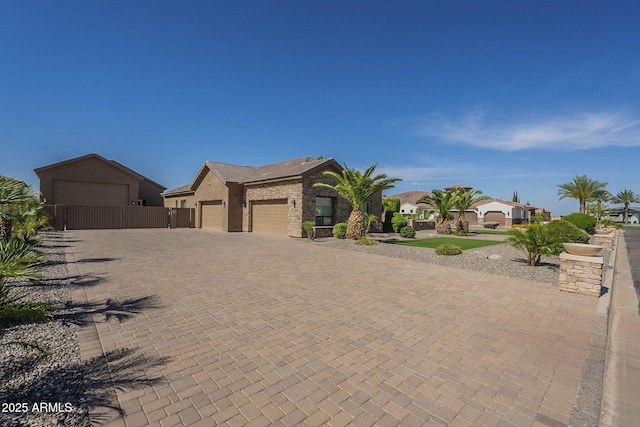 10033 W Jj Ranch Rd, Peoria, AZ 85383 - view of front of property featuring an attached garage, driveway, a residential view, and stucco siding