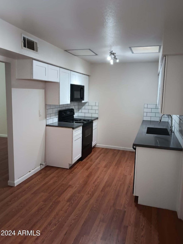 kitchen featuring dark wood-type flooring, sink, white cabinetry, decorative backsplash, and black appliances