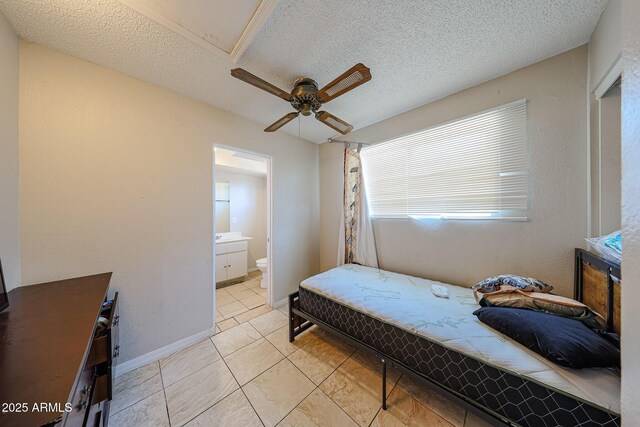 9021 W Mulberry Dr, Phoenix, AZ 85037 - bedroom featuring light tile patterned floors, ensuite bathroom, a ceiling fan, and a textured ceiling