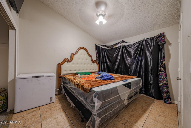 9021 W Mulberry Dr, Phoenix, AZ 85037 - bedroom featuring a textured ceiling, refrigerator, and light tile patterned floors