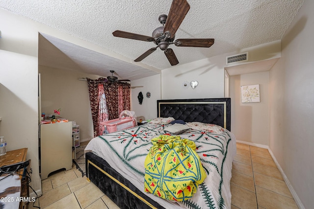 9021 W Mulberry Dr, Phoenix, AZ 85037 - tiled bedroom featuring baseboards, ceiling fan, a textured ceiling, and visible vents