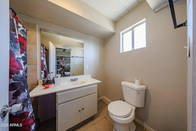 9021 W Mulberry Dr, Phoenix, AZ 85037 - full bathroom with baseboards, tile patterned flooring, vanity, and toilet