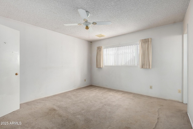 unfurnished room featuring visible vents, a textured ceiling, ceiling fan, and carpet floors