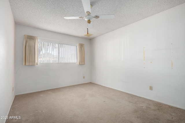 unfurnished room with ceiling fan, carpet flooring, and a textured ceiling