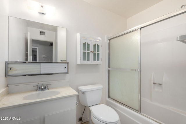 full bathroom featuring combined bath / shower with glass door, visible vents, toilet, and vanity