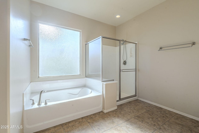 bathroom featuring independent shower and bath