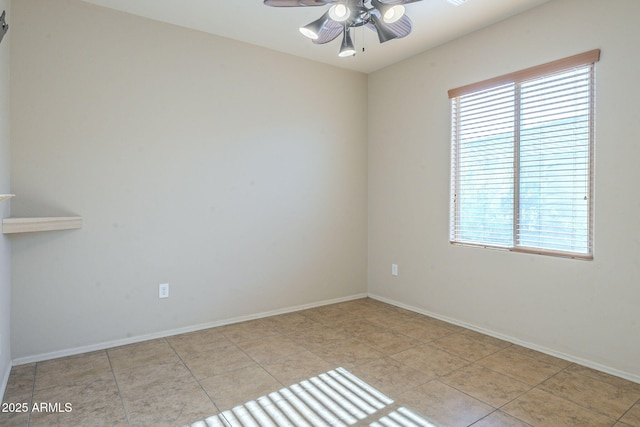 unfurnished room with ceiling fan and light tile patterned floors