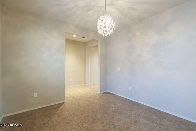 unfurnished room featuring a notable chandelier