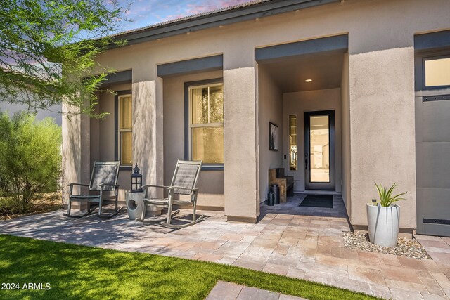 view of front of house with a front yard, a garage, and a patio area