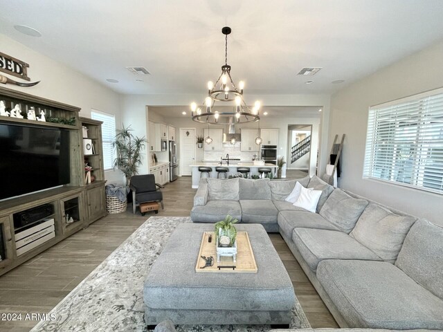 dining area with hardwood / wood-style floors and a chandelier